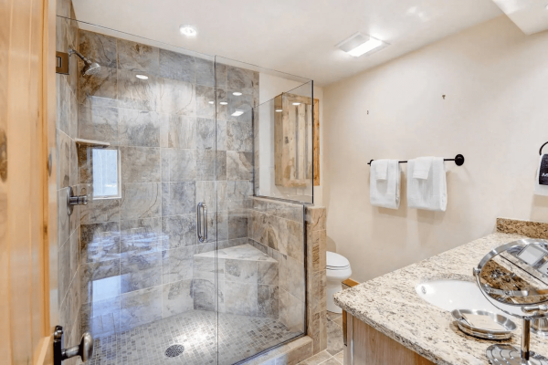 Primary bathroom with large walk in shower and double sinks.